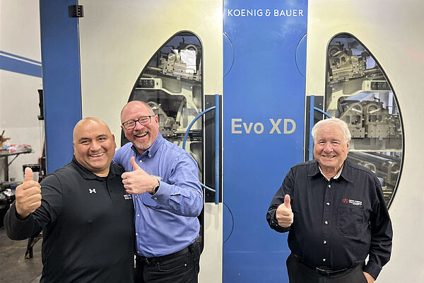 Great American Packaging's executive staff in front of Koenig & Bauer Flexo Press