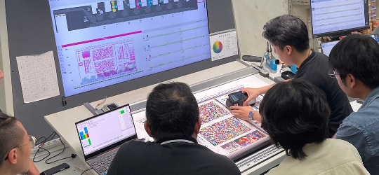 group of people looking at G7 color calibration on the computer