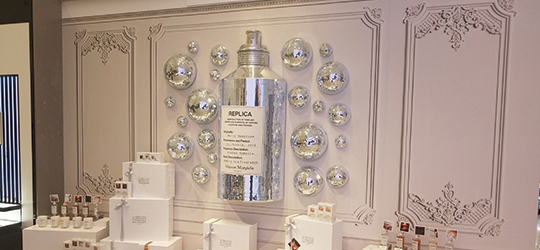 3D printed silver glass mirror balls and large metal bottle as wall decoration.