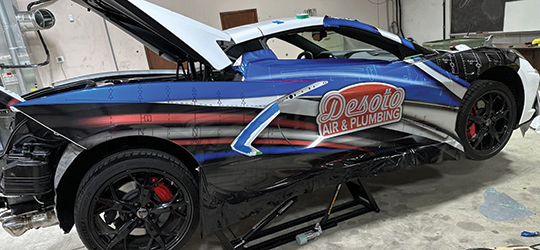 Sports car in the process of getting a vehicle wrap.