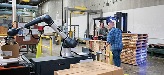 a robotic arm helps manage the production workflow
