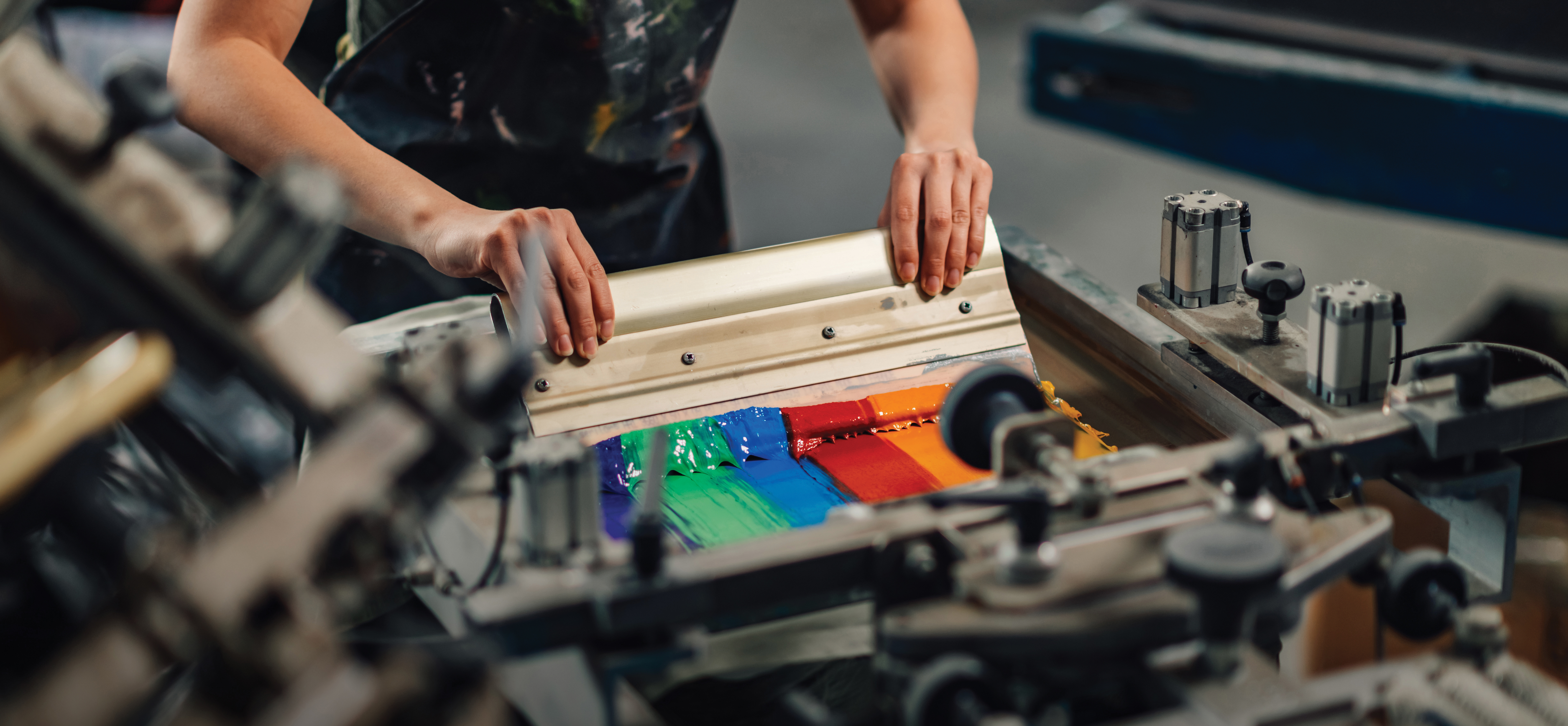 streaks of colored ink being used in a screen printing process