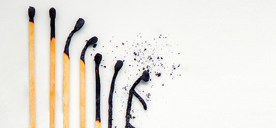 a lineup of burnt matchsticks, with each blackened more than the last