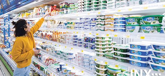 person shopping in a grocery store looking at packages