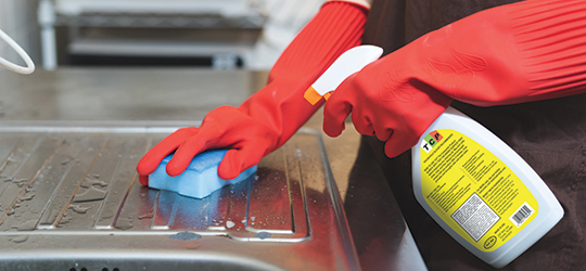 bright yellow label stands out on a spray bottle of cleaner