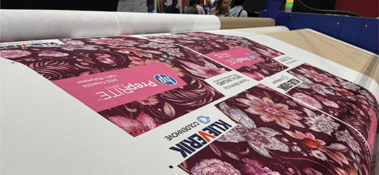 a pink digitally printed textile is rolled out